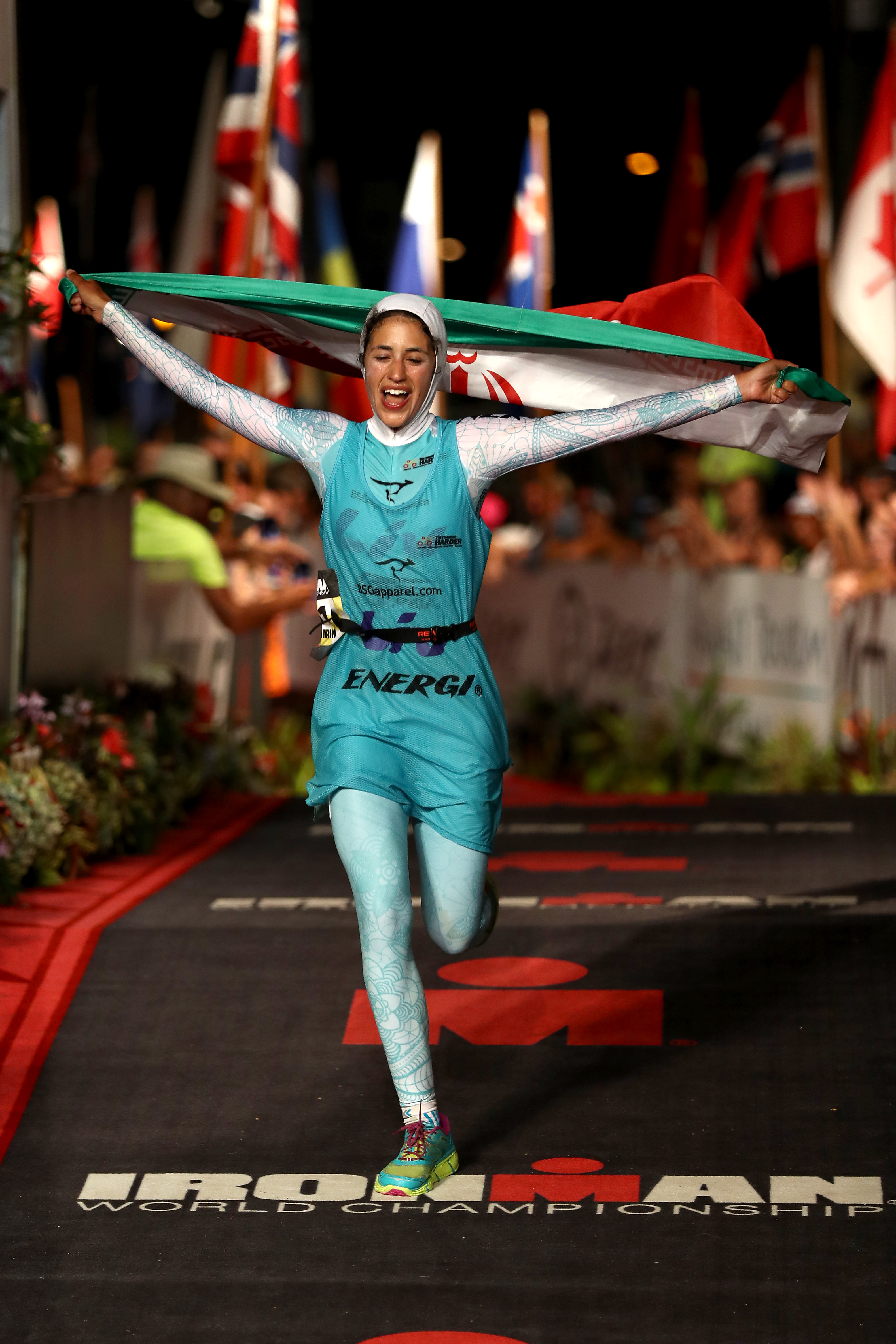 KAILUA KONA, HI - OCTOBER 08:  Shirin Girami #151 of Iran reacts after crossing the finish line in the 2016 IRONMAN World Championship triathlon on October 8, 2016 in Kailua Kona, Hawaii.  (Photo by Sean M. Haffey/Getty Images for Ironman)